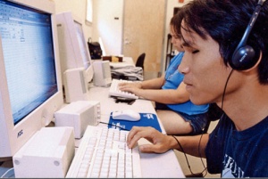 A photo of a visually impaired person using a screen reader computer program to read website content